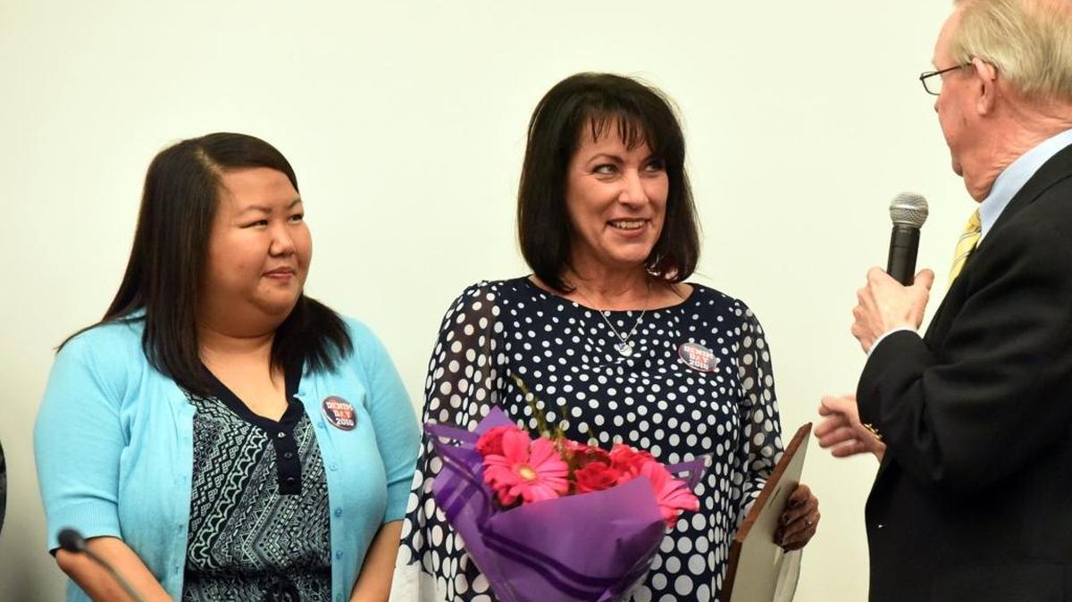 Valley Crisis Center volunteer Lara Olson, center, receives a volunteer recognition award for her work in Los Banos from Supervisor Jerry O’Banion on Tuesday, April 26, 2016. She was also given flowers from Valley Crisis Center Program Director Chee Yang, left.