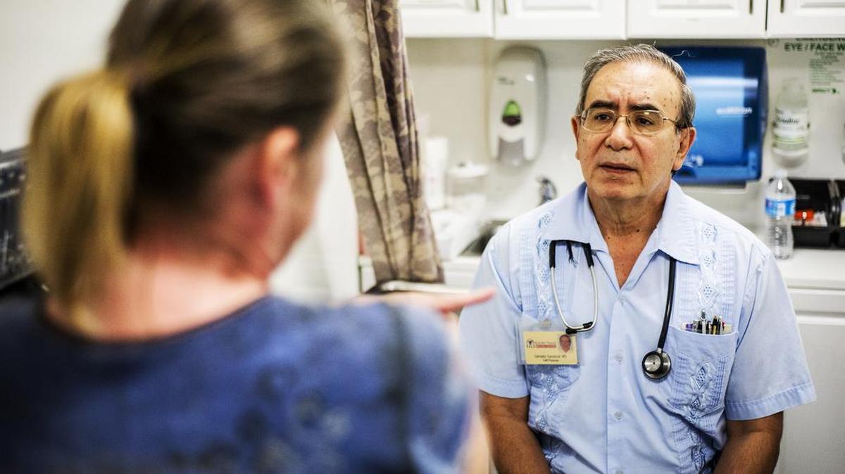 
Deretha Jones, 46, of Merced speaks with  Dr. Salvador Sandoval at the Golden Valley Health Centers’ mobile health clinic outside the East 15th Street homeless shelter in Merced, Calif., Tuesday, Oct. 6, 2015. Jones, currently homeless, has been staying at the  shelter. Sandoval is known in the community for his years spent working with the homeless and migrant workers.

