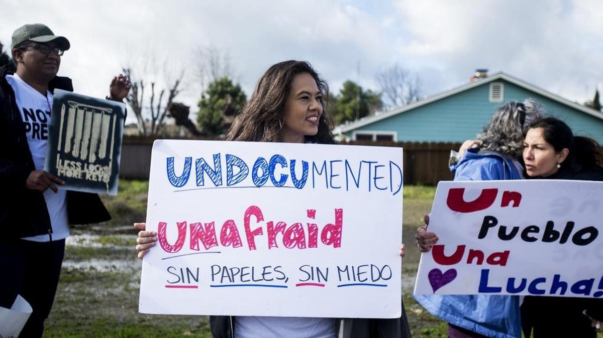 Protesters march along North Parsons Avenue in opposition of President Donald Trump in Merced on Friday.