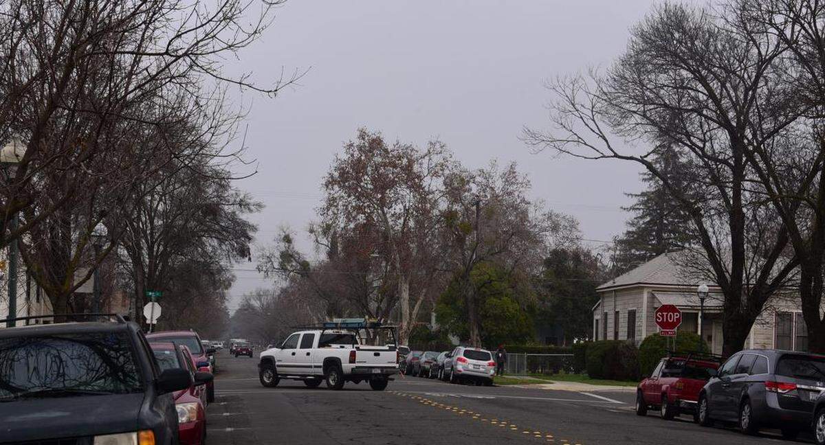 A white pickup truck turns left on W 18th Street from Martin Luther King Jr. way as dense fog hangs over Merced on Monday Jan. 15 2018.