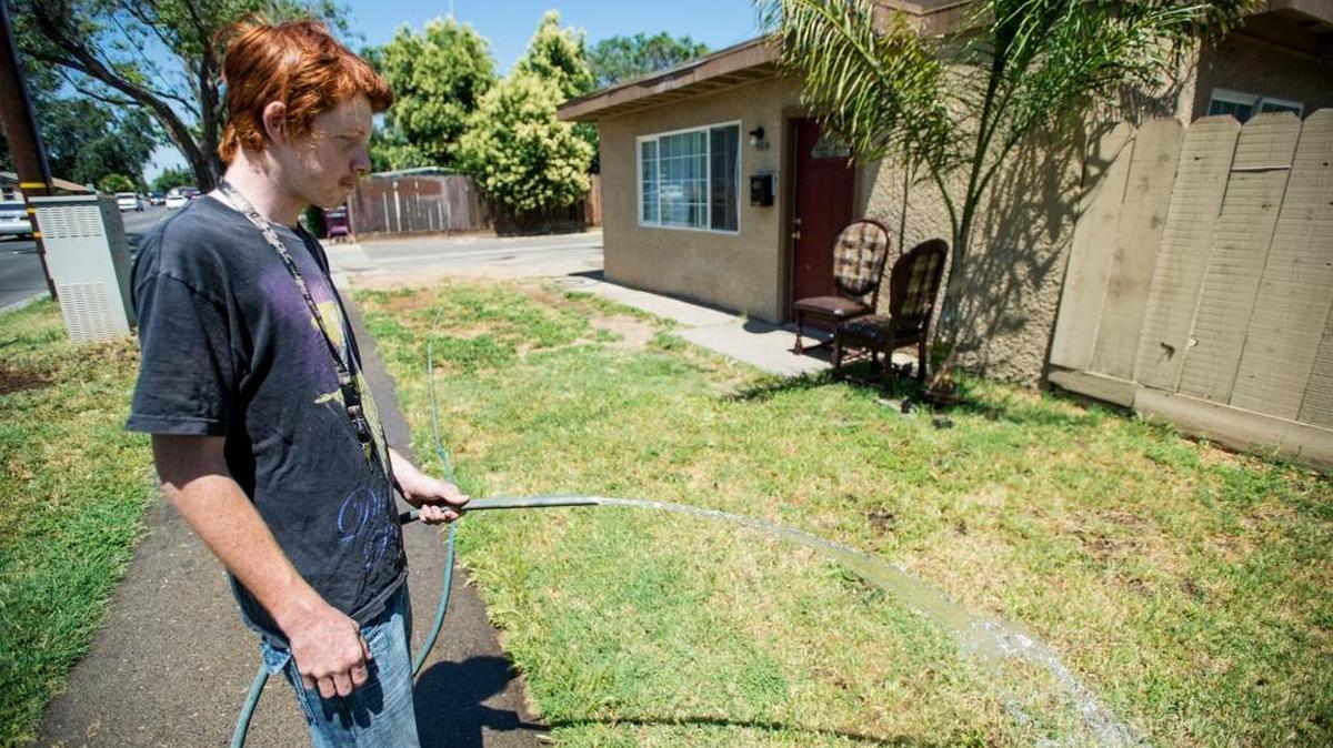 Ernie Thornton, 18, of Merced waters the lawn outside his home on R Street in Merced on Tuesday, May 31, 2016. The National Weather Service forecasts a high of about 105 on Saturday.
