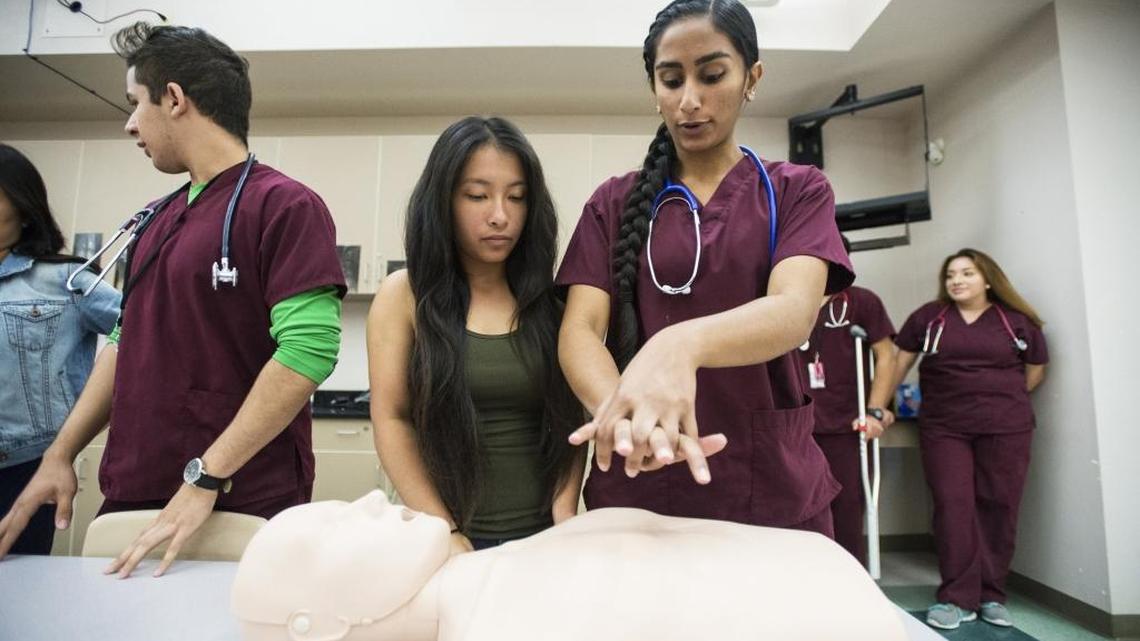 Delhi Medical Academy of Sciences certified nursing assistant student and Delhi senior Amandeep Sandhu, 17, right, instructs fellow senior Athena Nguyen, 17, on the proper technique when applying chest compressions during CPR during a sports medicine class at Delhi High School in Delhi, Calif., on Wednesday, Sept. 28, 2016.
