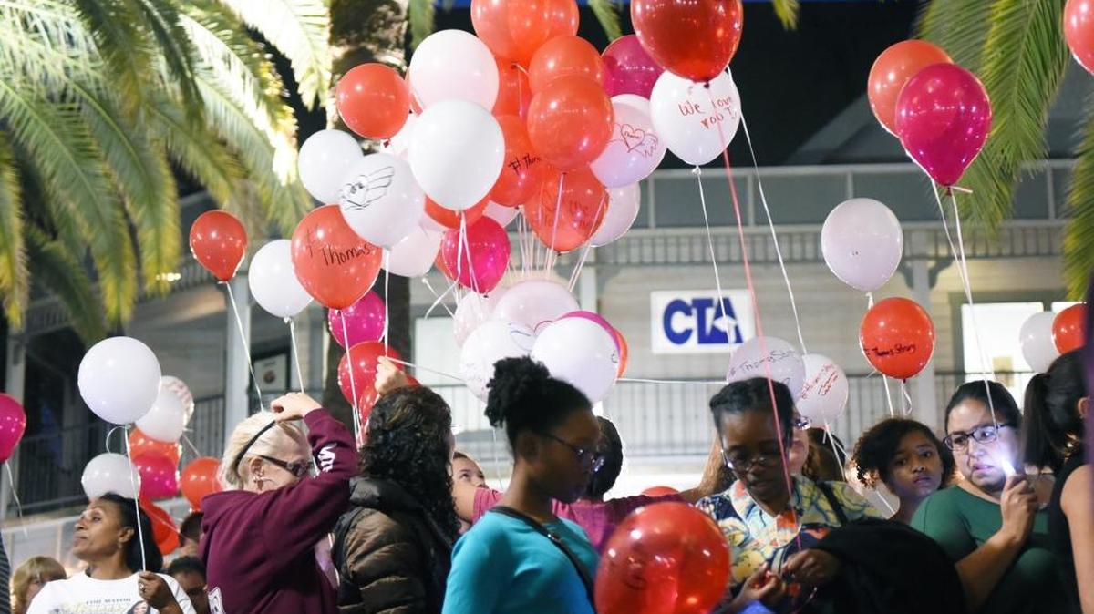 People in the community gather to celebrate the life of 6-month-old Thomas Chandler on Saturday at Bob Hart Square on Main Street in Merced. At the end of the memorial, hundreds of balloons were let go.