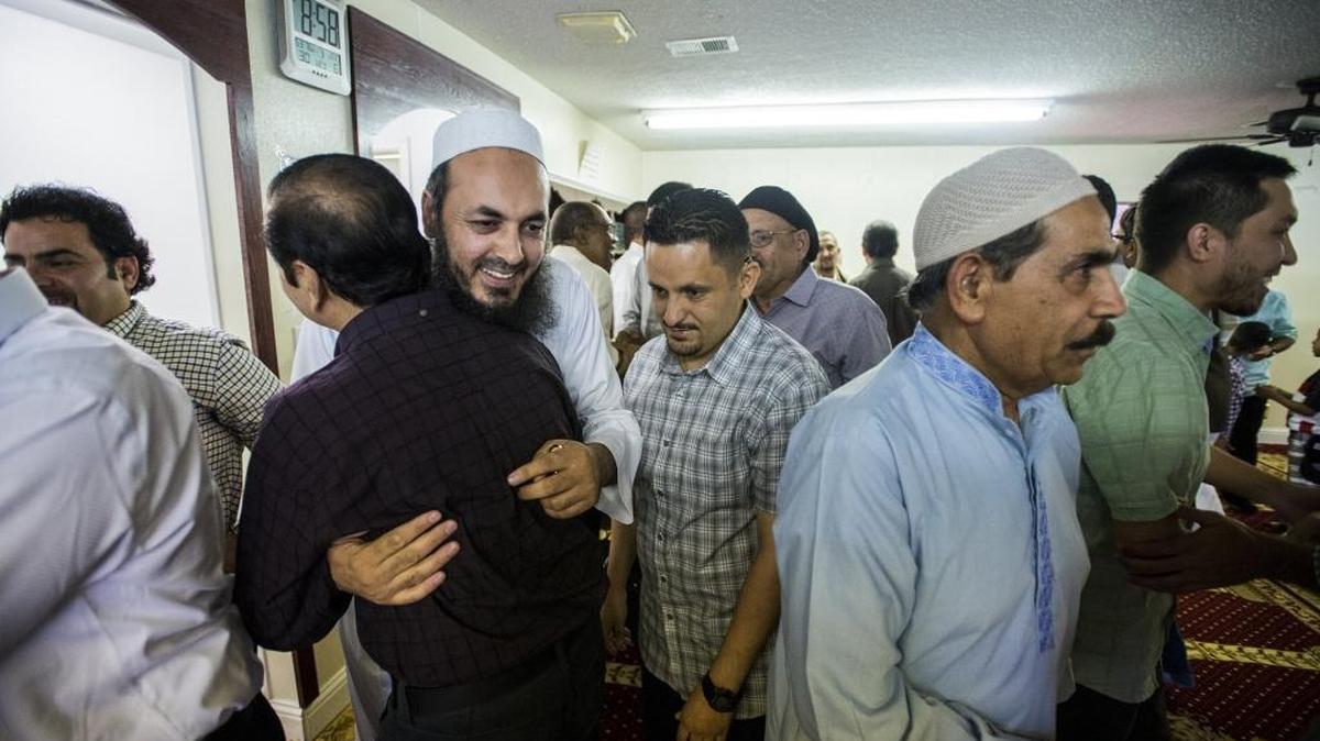 Imam Sanaullah Hussain hugs fellow Muslim men while observing Eid al-Fitr at the Islamic Center of Merced on Ashby Road on Wednesday, July 6, 2016.