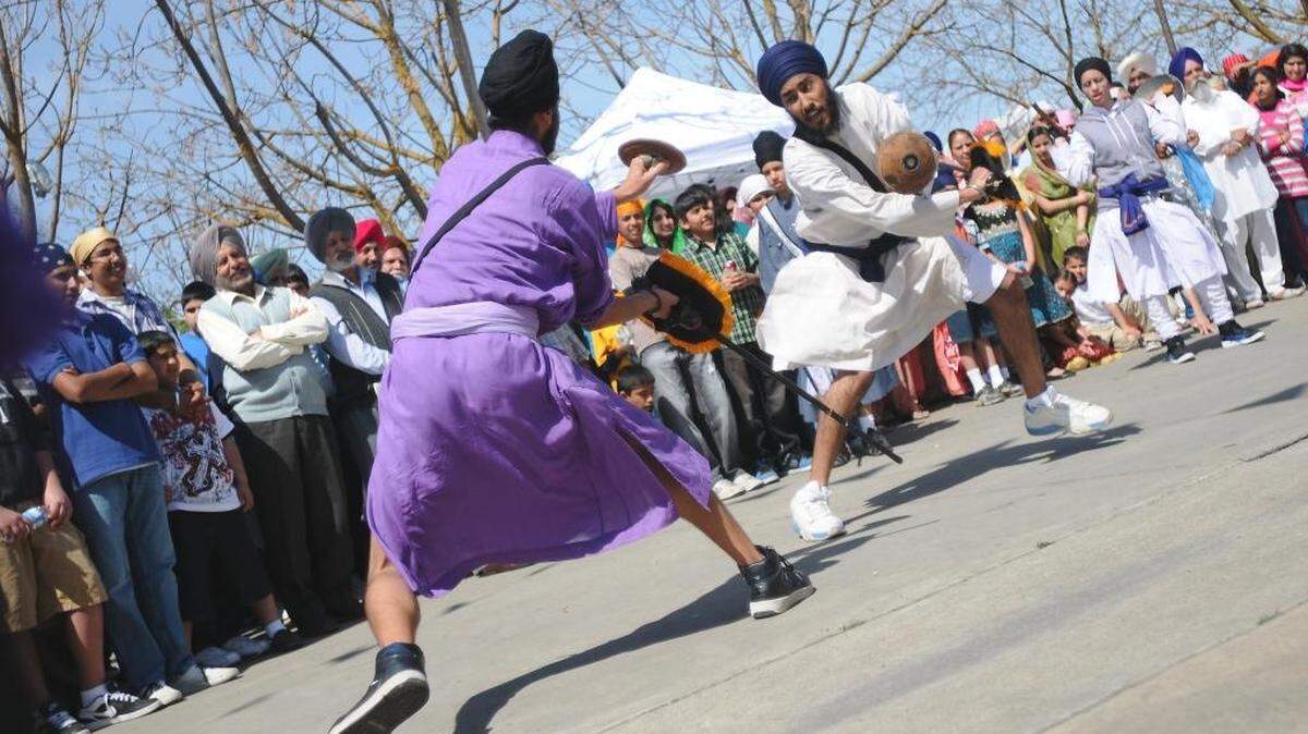 SUN-STAR PHOTO BY LISA JAMES Thousands of Sikhs traveled to Livingston on March 28, 2010, for the annual Sikh Parade, known in Sikhism as the holiday Hola Mohalla. Hola Mohalla is a martial arts festival and parade that celebrate the Sikh religion. Mock fighting and sword dancing along with other martial arts are performed along the parade route as a float carrying the Guru Granth Sahib, or Sikhism’s Holy Scripture, leads the procession from and back to the temple on Peach Street, stopping at the Guru Nanak Temple on B Street along the way. As the colorful procession winds its way through town, locals congregate on lawns to greet the participants, many with beverages and plates of homemade food. The traditions of Hola Mohalla, which translates to “mock fight,” dates back to the 1700s, when Sikhs would march from town to town, demonstrating their fighting skills. The Livingston parade is one of several in Central California that help Sikhs preserve their traditions while introducing fellow residents to Sikh culture.