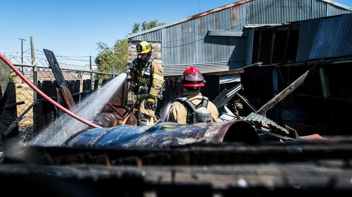 
Merced firefighters respond to a fence fire behind the TBA Auto Parts store at 948 West 15th St. in Merced on Wednesday. The fire appeared to have spread from a debris pile to a wooden fence. Firefighters were able to prevent the fire from spreading to the building.
