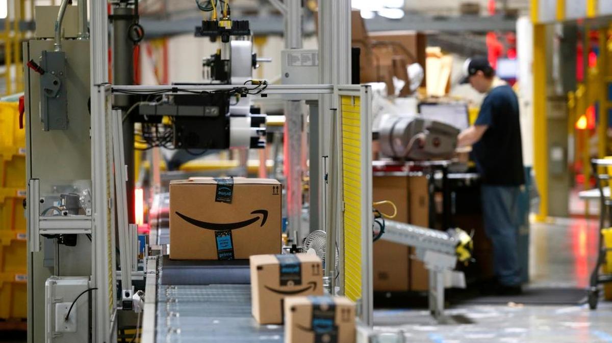 A single worker monitors an Amazon shipping line.