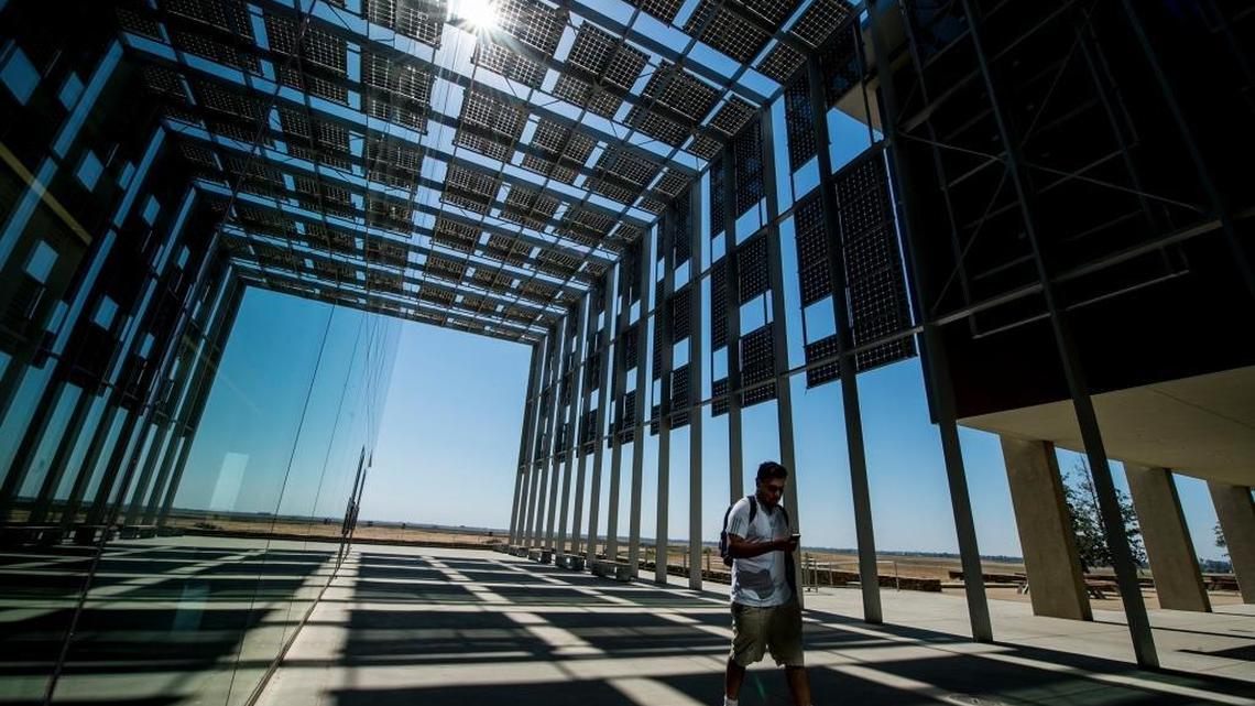 One of the allures of attending UC Merced is its world-class engineering department. Above, a student walks beneath solar panels on the Science and Engineering Building 2.