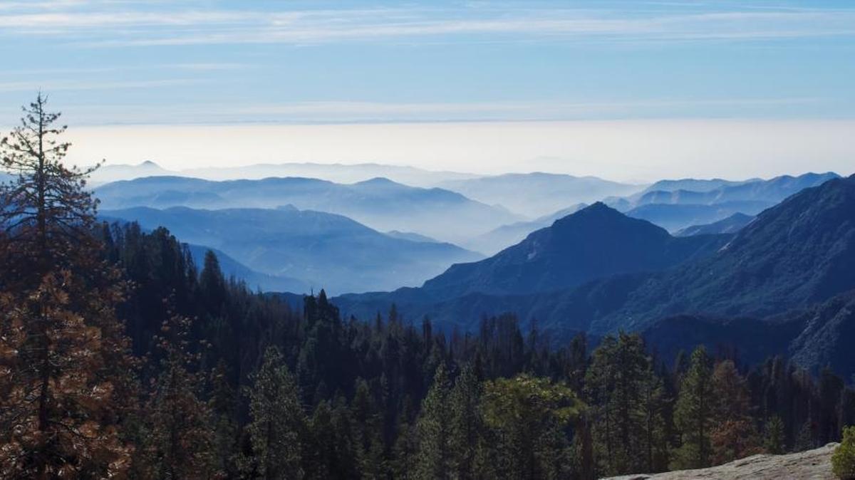 A haze can be seen blanketing the Valley floor; when it reaches the mountains, the pollution does even more damage.