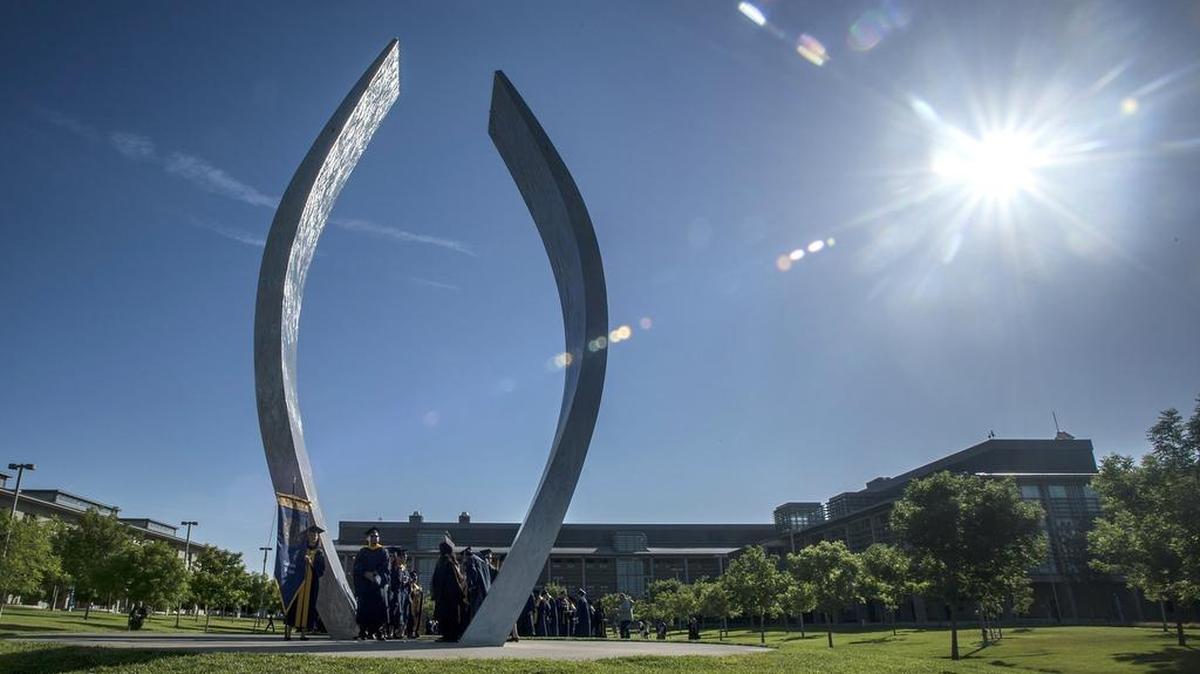 University of California, Merced graduates gather at the campus sculpture titled “Beginnings.” Bringing a new medical school to the Valley would help with our healthcare situation.