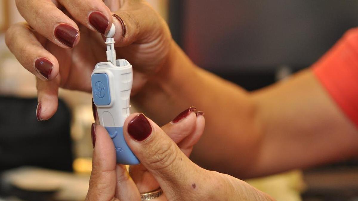 A health specialist at Golden Valley Health Center shows a patient how to check blood glucose levels with a simple, and inexpensive monitoring system. Assemblyman Adam Gray wants to make such tools available to those who rely on Medi-Cal for treatment.