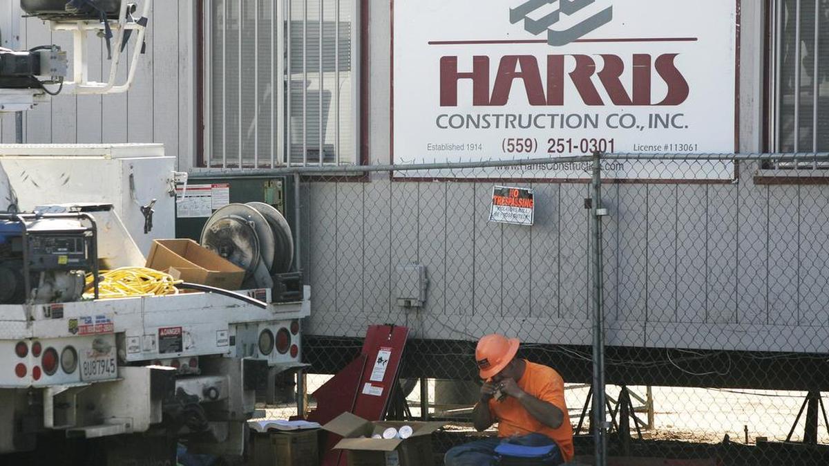 A construction worker eats lunch outside the office where Fresno Unified’s new Gaston Middle School was being built in October 2012. An appellate court declared the no-bid contract for the school a violation of state conflict-of-interest laws.