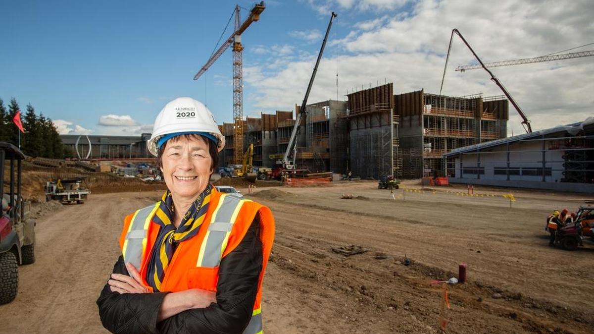 UC Merced Chancellor Dorothy Leland at UC Merced, standing in front of new construction in February 12.