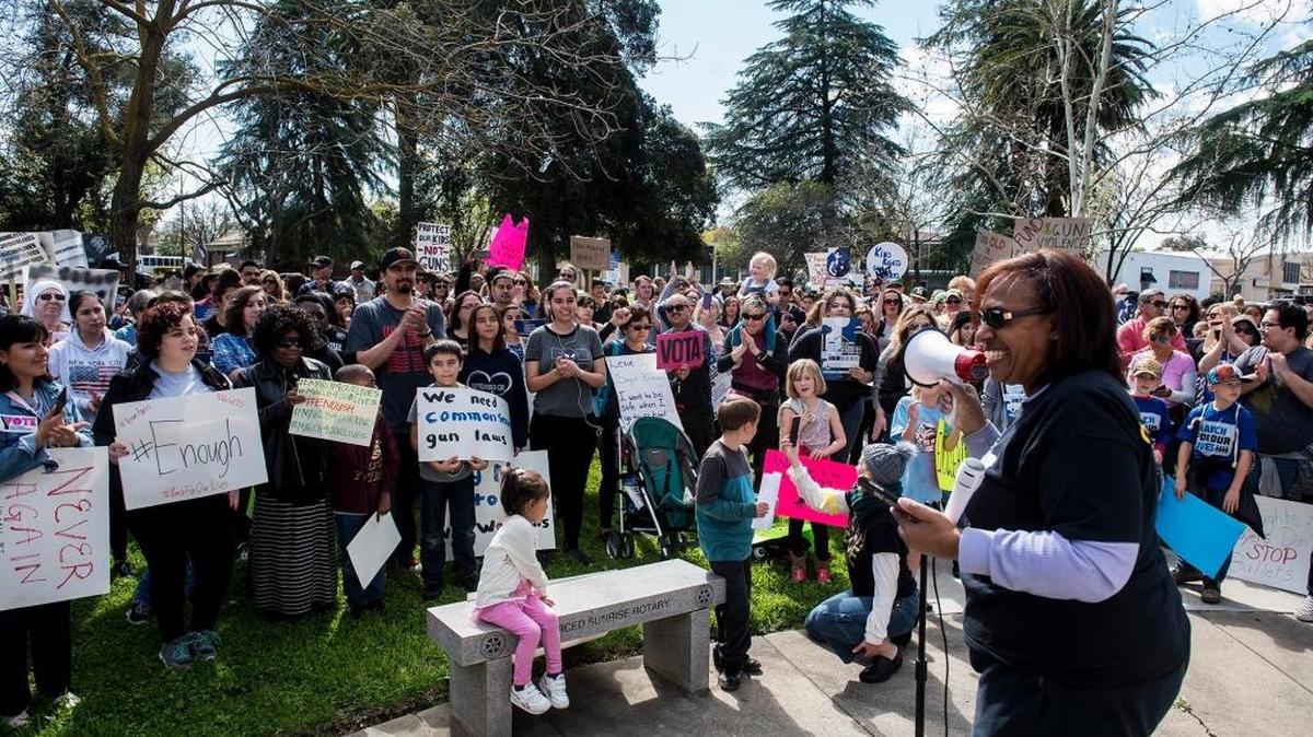 People cheer as community activist Necola Adams speaks during a “March for Our Lives” rally calling for stricter gun control laws at Courthouse Park in Merced on March 24.