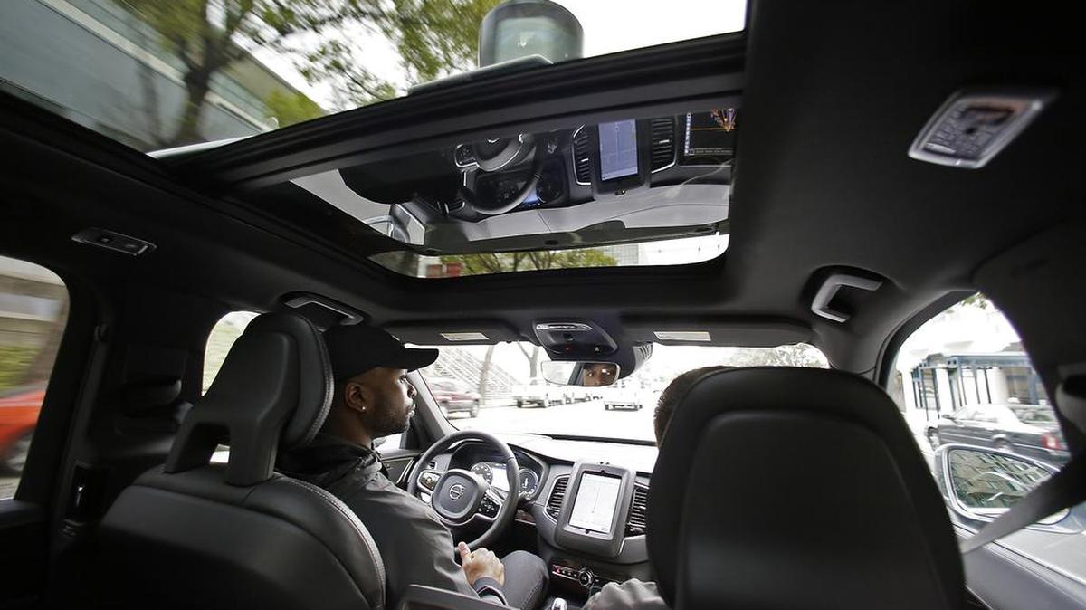 Devin Greene sits in the front seat of an Uber driverless car during a test drive in San Francisco in December. Uber, unable to reach a deal with California regulators, moved the self-driving Volvos to Arizona. Testing of the SUVs will resume near Phoenix, where Google also tests driverless cars.