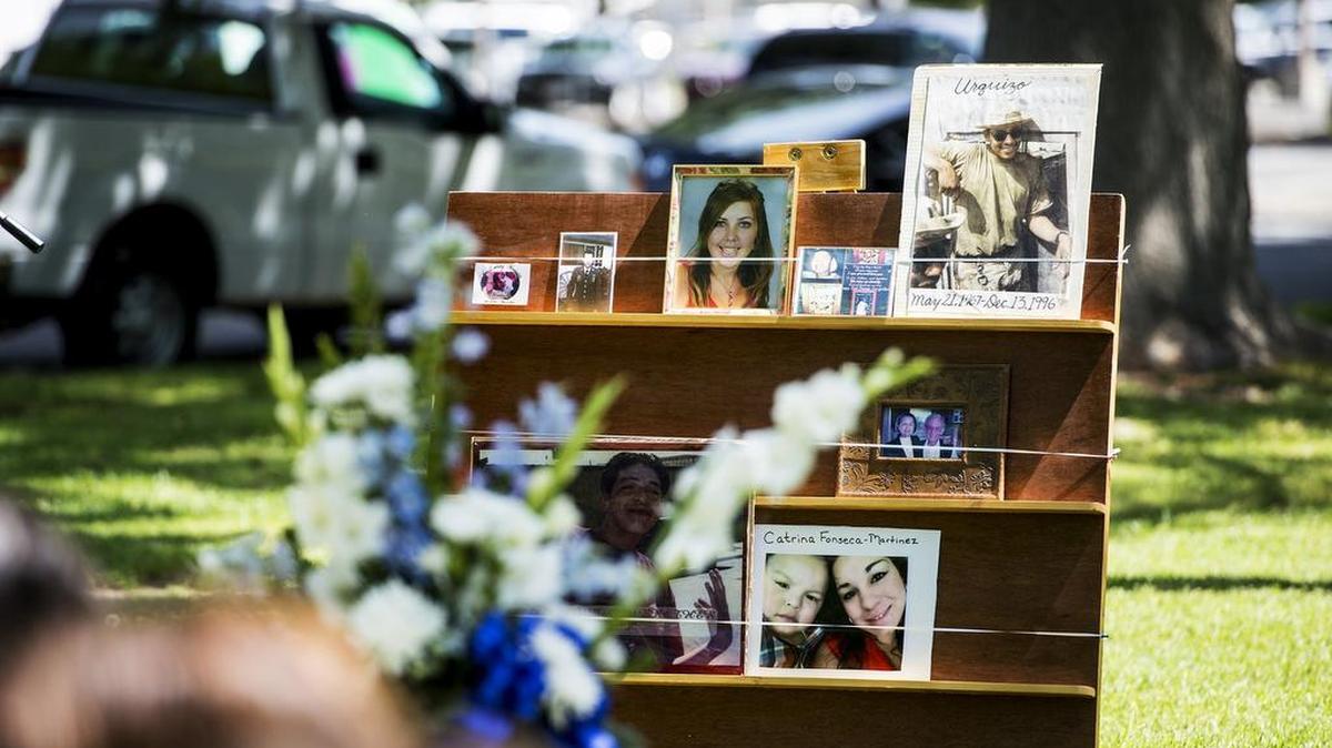 Photographs of murder victims are displayed during a victims’ rights ceremony at Courthouse Park in Merced Calif., Thursday, April 14, 2016.