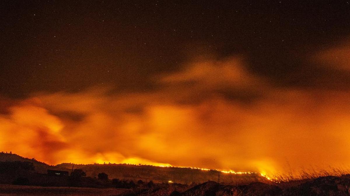 The Camp Fire burns as it lights up the sky under bright stars  Nov. 8 in Paradise. At least 71 people died. President Trump visits the area Saturday, and his agriculture and interior secretaries are blaming environmental groups for the state’s wildfire disasters.