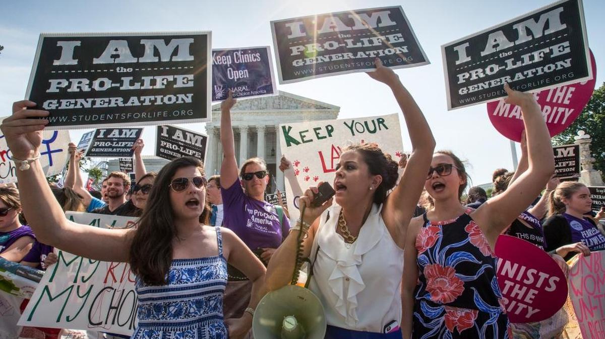 Reagan Barklage of St. Louis, center, and other anti-abortion activists demonstrate in front of the Supreme Court in Washington, Monday, June 27, 2016, as the justices struck down the strict Texas anti-abortion restriction law known as HB2. The justices voted 5-3 in favor of Texas clinics that had argued the regulations were a thinly veiled attempt to make it harder for women to get an abortion in the nation’s second-most populous state.