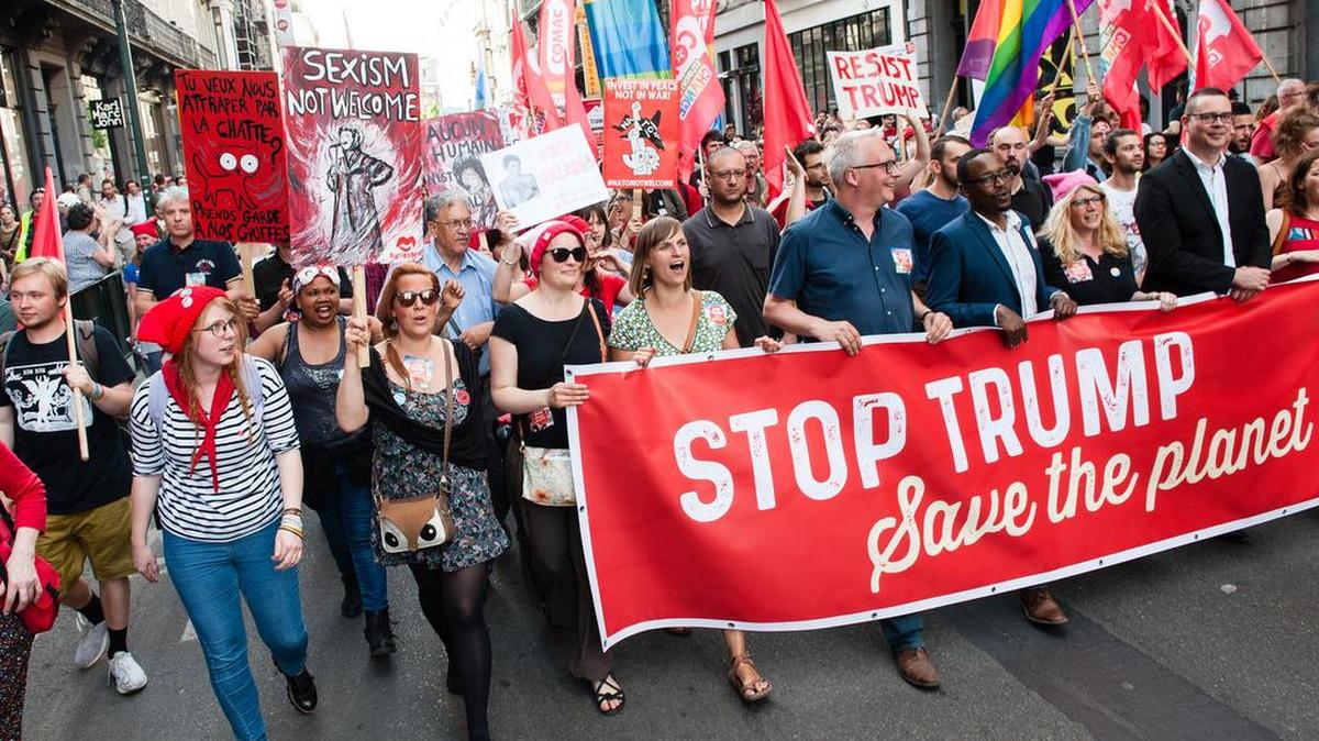 Demonstrators gather in Brussels to protest against President Donald Trump.