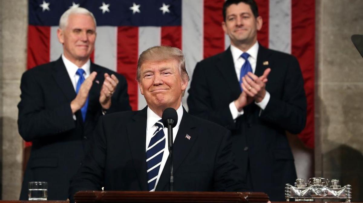President Donald Trump is flanked by Vice President Mike Pence and House Speaker Paul Ryan of Wisconsin before his speech to a joint session of Congress on Tuesday.