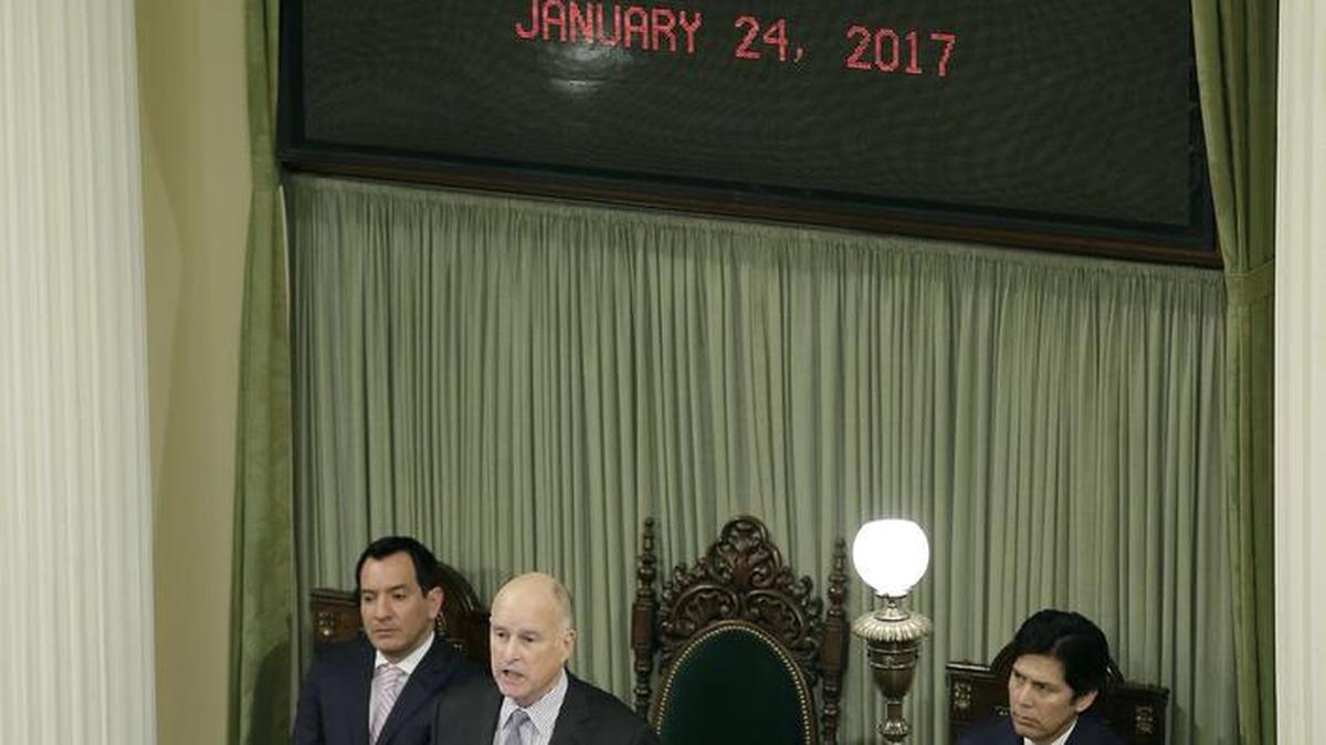 Gov. Jerry Brown delivers his annual State of the State address before a joint session of the California Legislature on Tuesday in Sacramento. Seated behind him are Assembly Speaker Anthony Rendon, D-Paramount, left, and Senate President Pro Tem Kevin de León, D-Los Angeles, right.