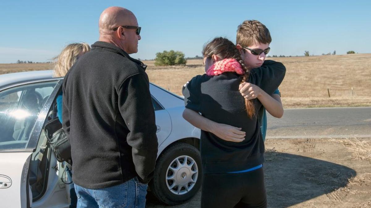 UC Merced student Justin Dick hugs his sister Kristen as their parents Beth and Keith look on after an assailant with a knife stabbed four people and was later shot and killed by law enforcement on campus Wednesday.