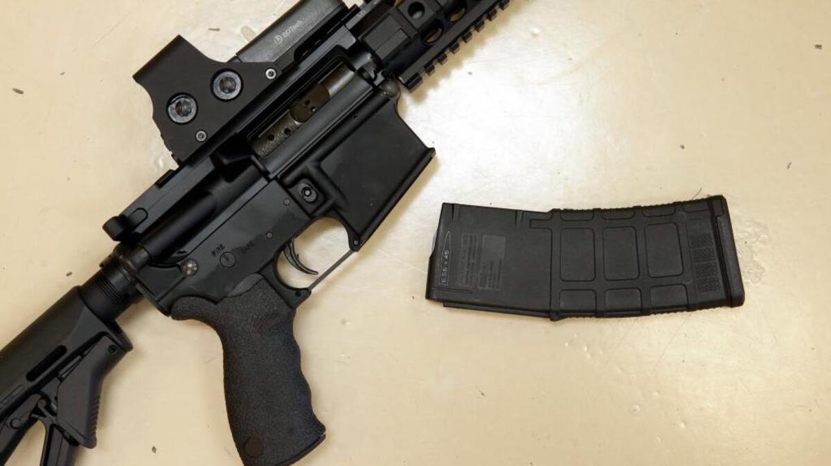 A custom-made semi-automatic hunting rifle with a high-capacity detachable magazine is displayed at TDS Guns in Rocklin. Though California has some of the nation’s toughest gun control laws, they are only as strong as enforcement in bordering states.