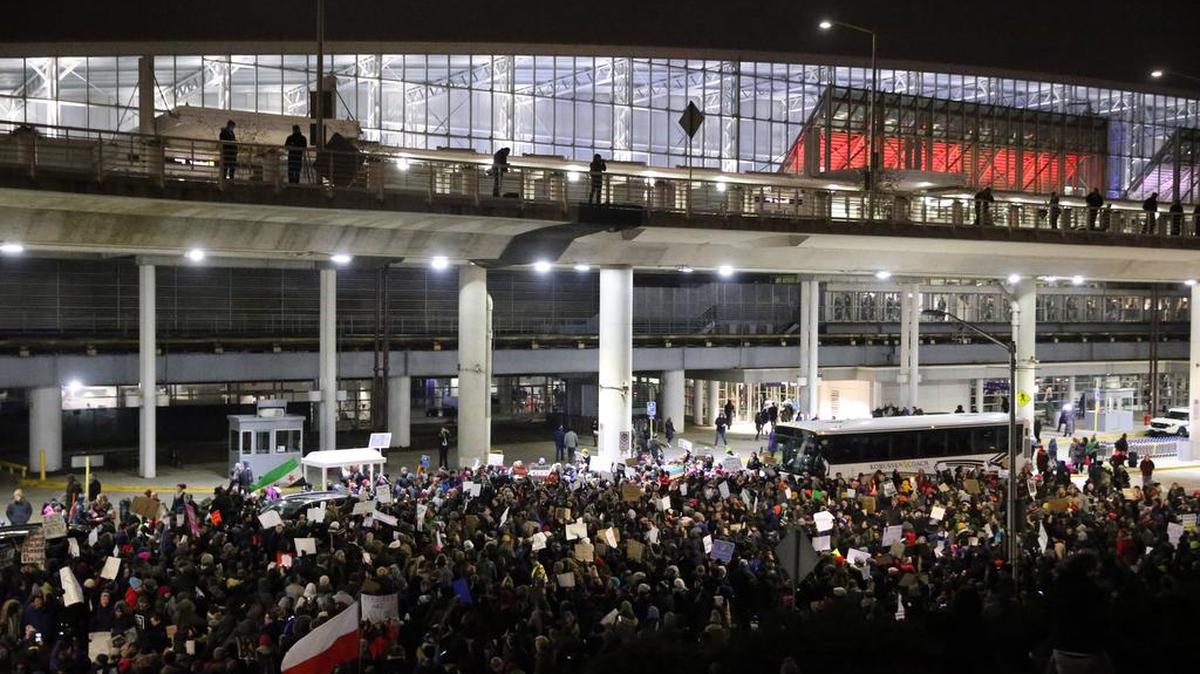 Protesters gather Saturday at O’Hare International Airport after more than a dozen were detained, including green card holders, in Chicago. President Donald Trump’s executive order on Friday banned legal U.S. residents and visa holders from seven Muslim-majority nations from entering the U.S. for 90 days and put an indefinite hold on a program resettling Syrian refugees.