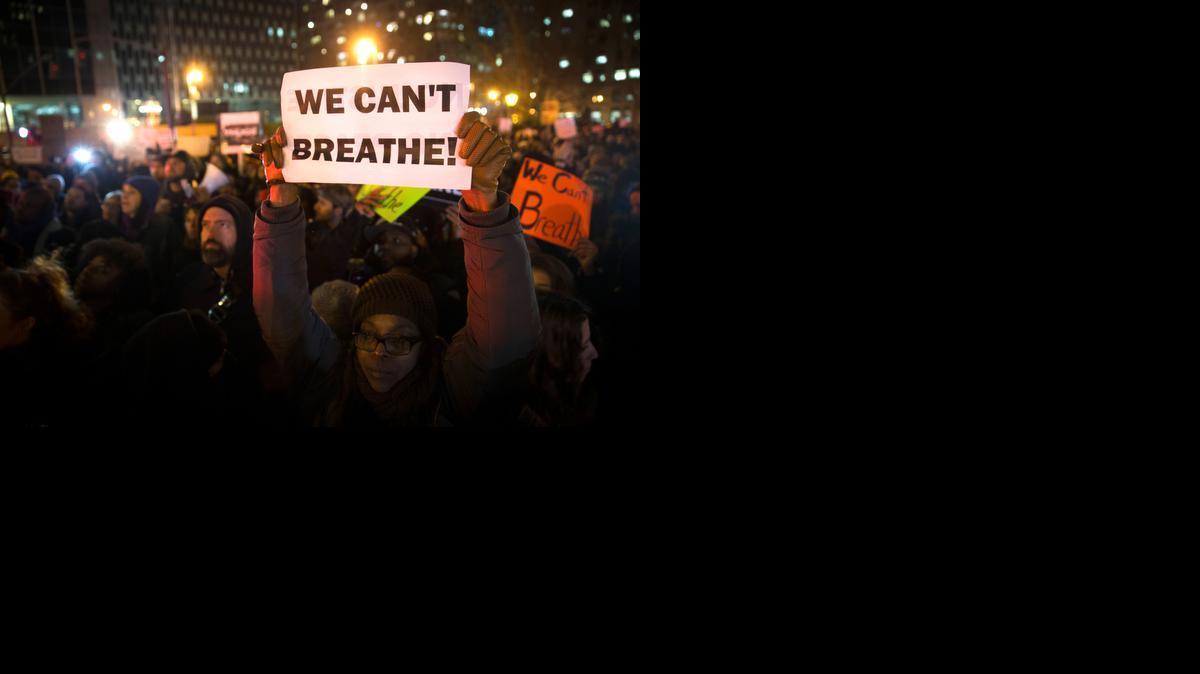 
Demonstrators participate in a rally Thursday after a grand jury decided not to indict the New York police officer involved in the death of Eric Garner. A video showed the white officer putting Garner, an unarmed black man, in a chokehold and Garner gasping, “I can’t breathe.” Garner had been stopped on suspicion of selling loose, untaxed cigarettes.
