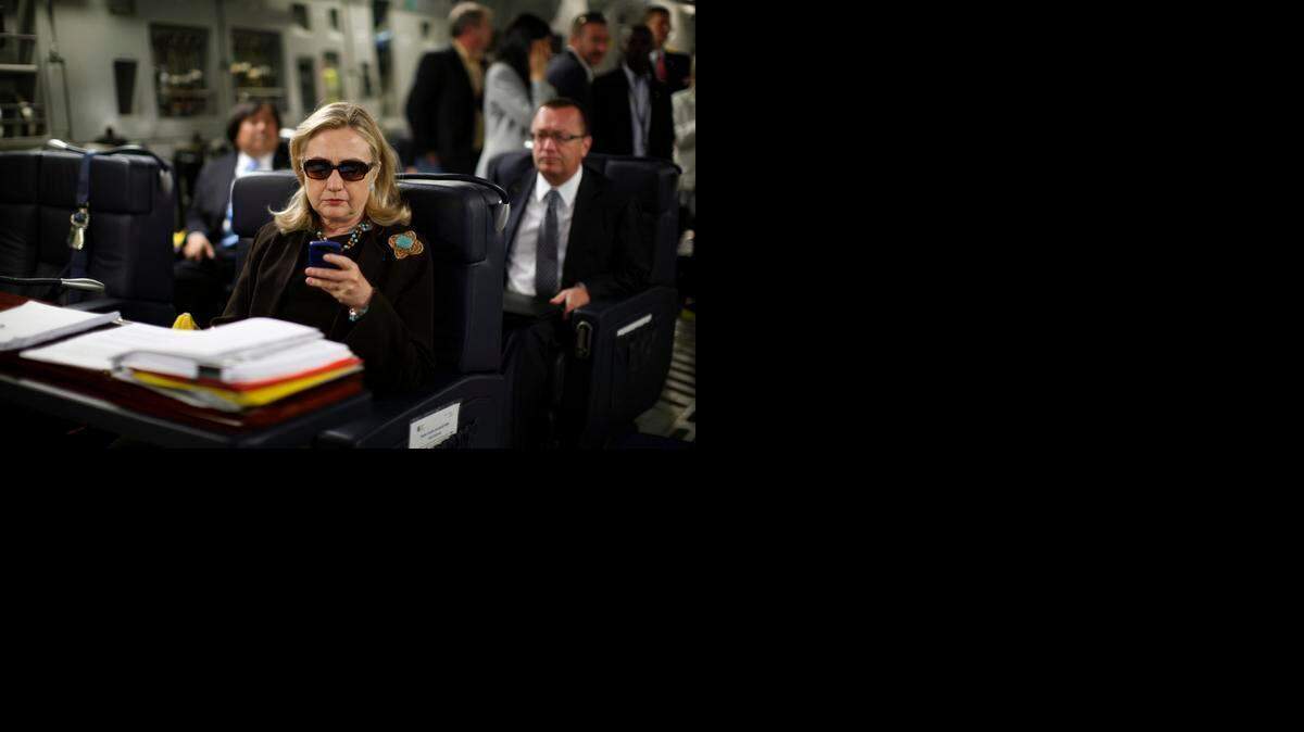 
Hillary Clinton works from a desk inside a C-17 military plane on the way from Malta to Libya in 2011. She used only a personal email account during her four years as secretary of state.
