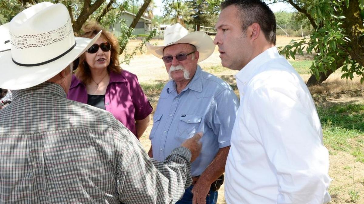 Adam Gray, right, meets with local leaders near a well in Le Grand to discuss community water issues.