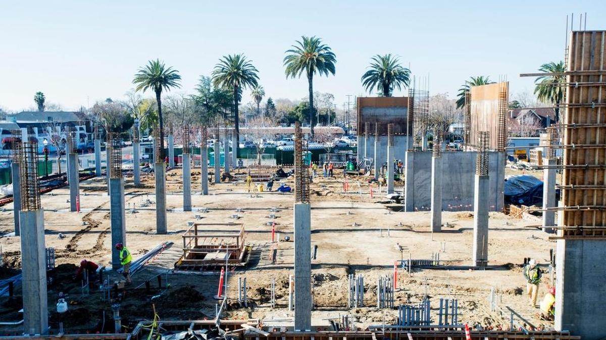 Construction crews work at the site of the future University of California, Merced, Downtown Center at the corner of West 18th Street and N Street in Merced on Wednesday. According to the university, the lot is expected to be home to a 67,400-square-foot facility capable of housing more than 300 employees.