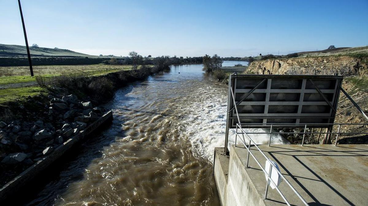 Water flows at a rate of 250 cubic feet per second from the McSwain Dam in Snelling. Two UC professors, one from Berkeley and one from Merced, urge support for a more modern system of tracking water flows and use.