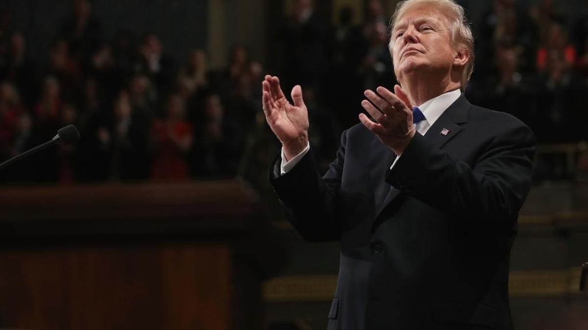 President Donald Trump claps at his first State of the Union address in the House chamber of the U.S. Capitol to a joint session of Congress.
