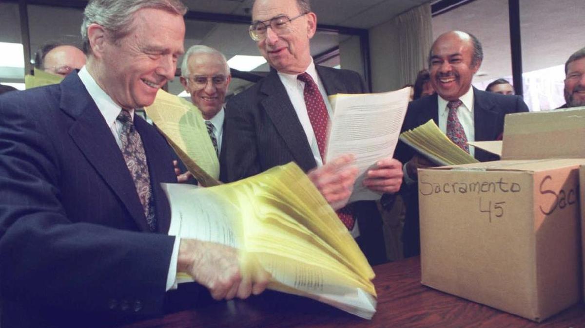 Gov. Pete Wilson, state Sen. Quentin Kopp, and UC Regent Ward Connerly turn in more than 1 million signatures on Feb. 21, 1996, to qualify an initiative. Kopp, who is also a retired judge as well as a retired legislator, is suing to overturn a law passed in 2016 that purports to legalize public financing of campaigns.