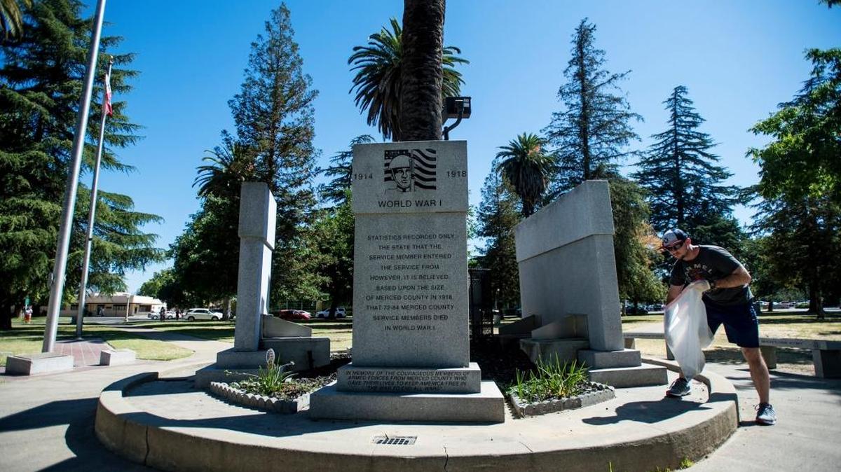 Caleb Henke, 25, of Merced, cleans up around the Veterans Memorial at Courthouse Park. We should honor those who have fallen by renaming city streets in their memory.