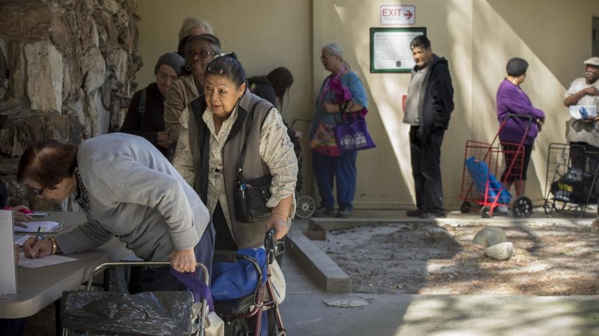 Senior citizens line up for free groceries on March 16 at the Hart Senior Center, where once a month, about 45 seniors bring wheeled carts to fill up with potatoes, rice, fresh fruits and vegetables and other staples, mostly provided by the Sacramento Food Bank. California will see a sharp increase in its elderly population as the baby boom generation retires from the workforce.
