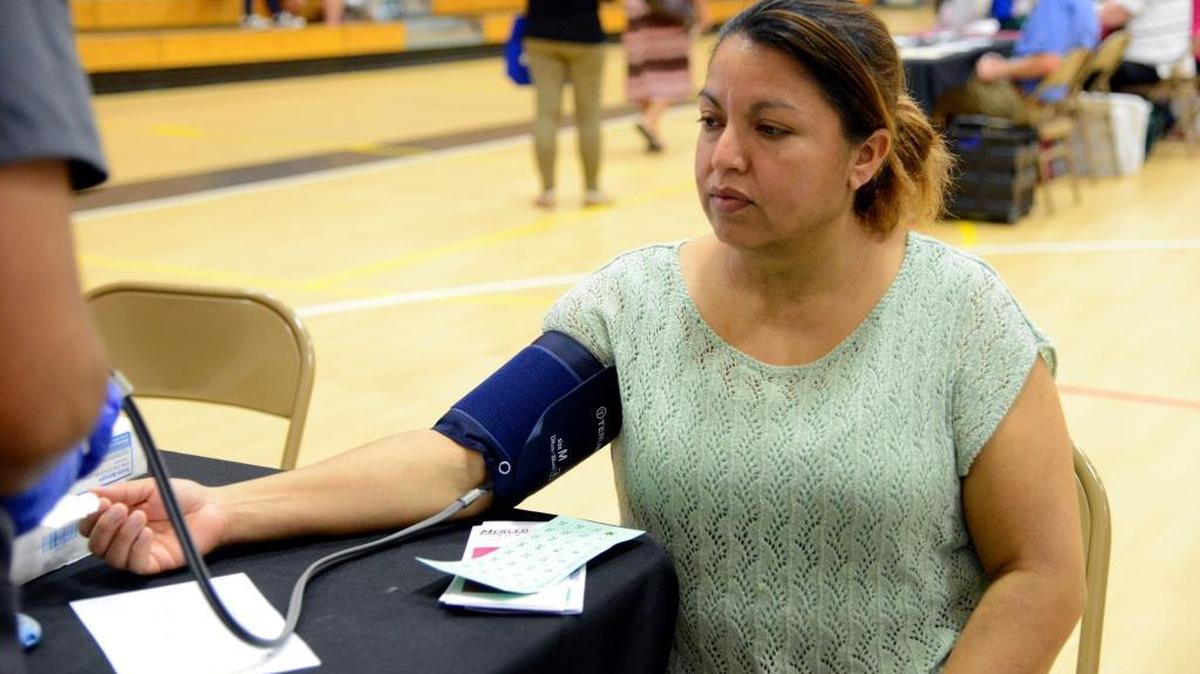 
Maria Cortez, 44, of Delhi has her blood pressure checked at a health and safety fair at Delhi Middle School on Thursday.
