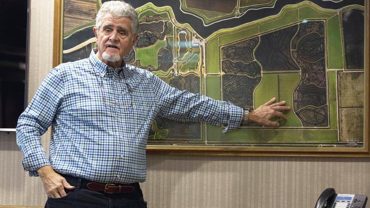 Dean Cortopassi gestures to an aerial photo of land he owns in the Sacramento-San Joaquin River Delta. Cortopassi, a wealthy farmer and food processor, is bankrolling Proposition 53, which would require a statewide vote before issuing revenue bonds to fund mega-projects. He’s strongly opposed to Gov. Jerry Brown’s “twin tunnels” project in the Delta and Proposition 53 could subject it to a statewide vote.