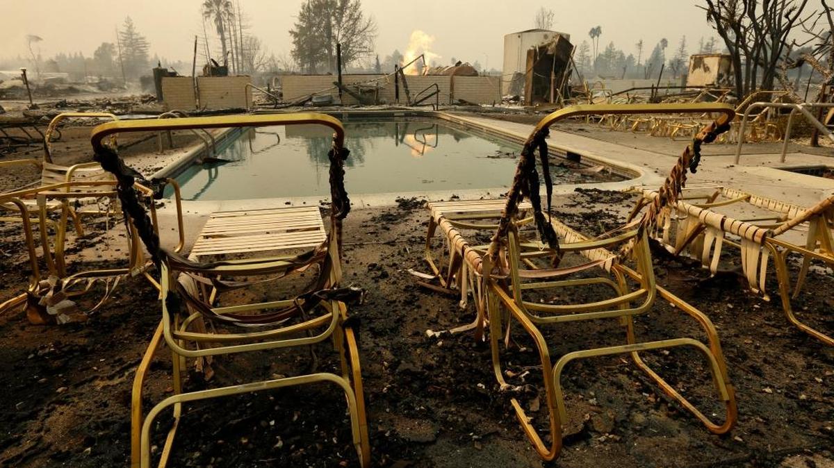 Fire burns from an open gas valve near the pool area at the Journey’s End mobile home park in Santa Rosa shortly after the October wildfires. All of the mobile homes in the park were destroyed.