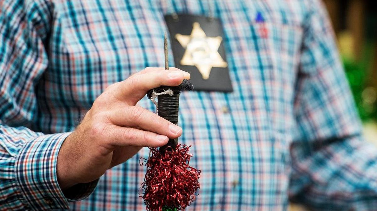 Merced County Sheriff Vern Warnke holds a sharp-tipped bandeira, recovered from a Turlock Pentecost Association bloodless bullfight, during a news conference Tuesday.
