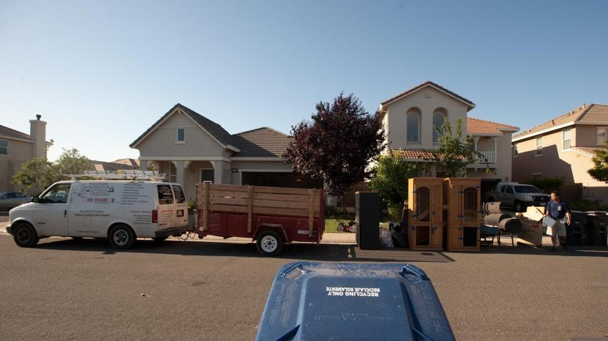In ths 2012 photo, a work van and trailer are parked near unwanted furniture next to the home, left, that Toby Lopez and his family had been renting for the prevous two years in the Anatolia neighborhood of Rancho Cordova. The home was being foreclosed, and the family was moving to Missouri. The home on the far left had also just gone through a foreclosure. At the time, more than half of homeowners in the Sacramento region owed more than their homes were worth, amounting to about $21 billion in negative equity.