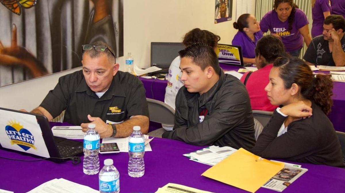 This photo provided by the Service Employees International Union shows a couple reviewing health care plans at an Affordable Care Act enrollment event sponsored by SEIU-United Healthcare Workers West and Community Coalition, in Los Angeles on Nov. 15, 2014.