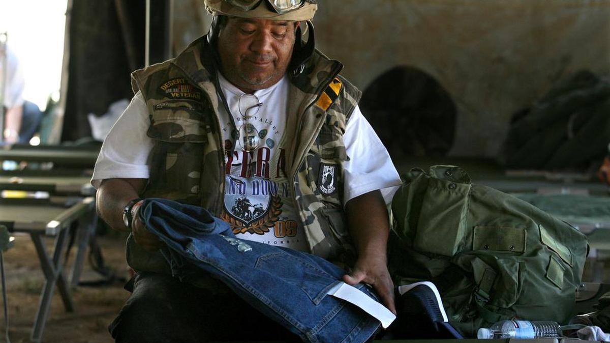 Arthur Casares, a homeless Desert Storm Army veteran, admires his new pair of jeans during the Central Valley Veterans Stand Down in 2009 at VFW Post 8900 in Fresno. Only half of California’s 58 counties offer veterans’ treatment courts, which help struggling veterans fully rejoin society. AB 1672 would study the effectiveness of veterans’ courts and open the door to their expansion.