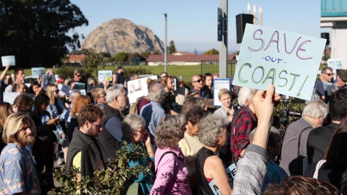 Coastal protection advocates gather outside the Morro Bay Community Center on Feb. 9, 2016, awaiting a meeting at which Charles Lester, the Coastal Commission’s executive director, was fired. His dismissal sparked efforts in the Legislature to ban “ex parte” communications between commission members and those with projects awaiting decisions.
