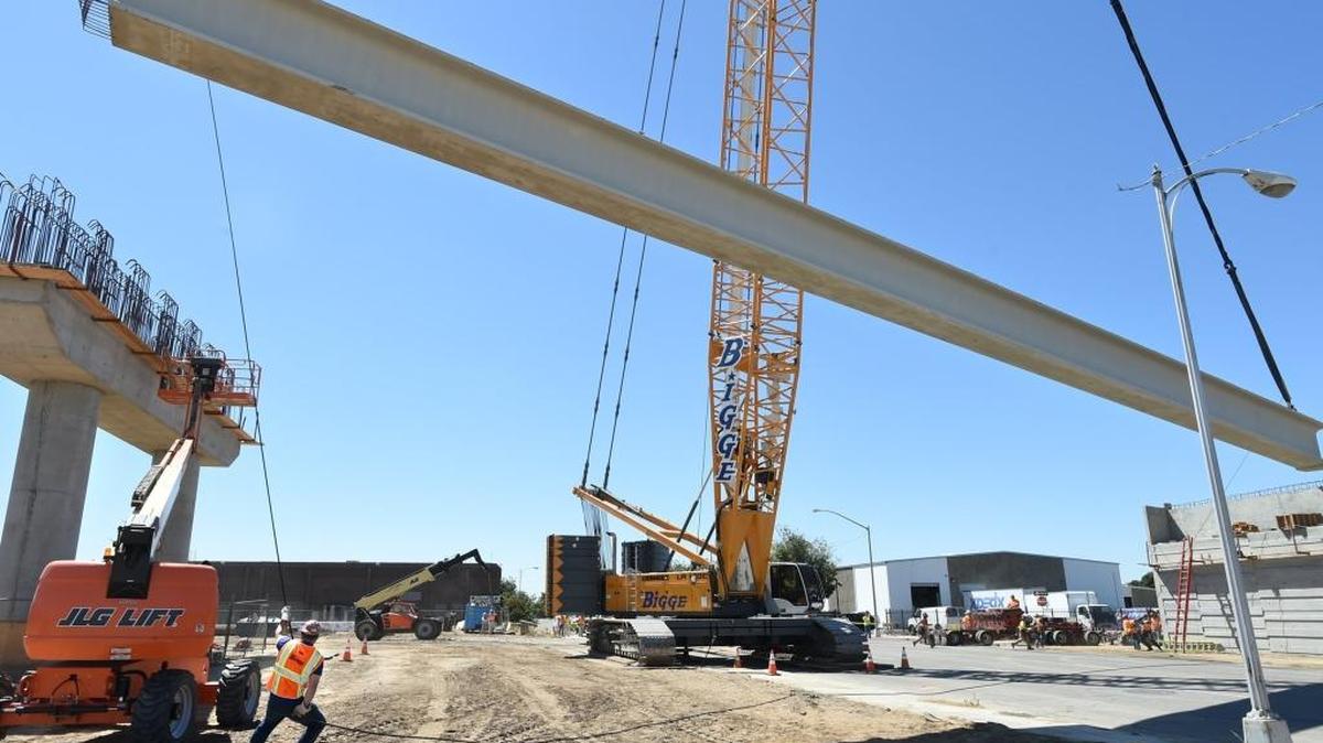 A crane lowers 146-foot, concrete and steel girder, weighing 166,000 pounds, into place as the Tuolumne Street bridge in downtown Fresno was replaced to facilitate the high-speed rail station being built in the city. It will include a stop in Merced when complete.