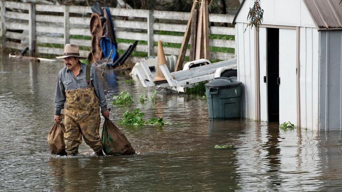 Alberto Bolanos pulls items from a storage shed after flooding along the Tuolumne River at his home south west of Modesto in 2017.