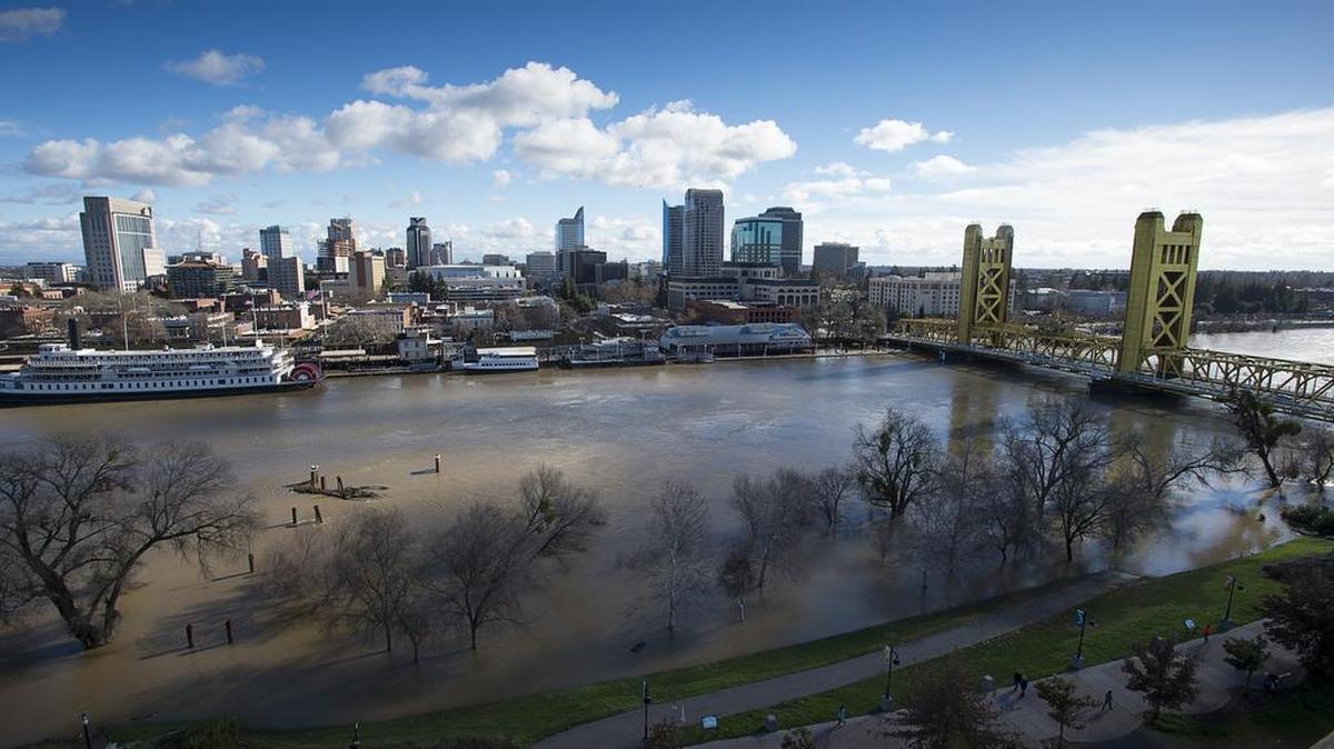 The Sacramento River flows almost bank-to-bank past downtown Sacramento after heavy rains on Wednesday, Jan. 11, carrying millions of gallons to the Pacific Ocean.