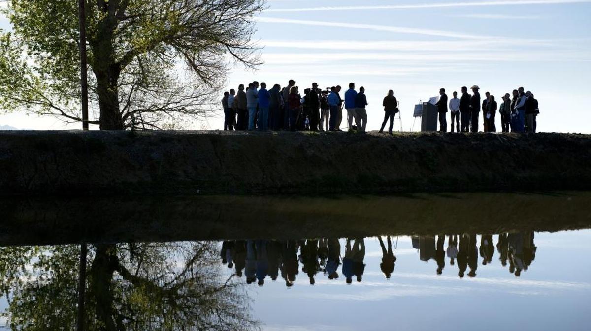 Lawmakers and supporters stand on the levee above the Glenn-Colusa Irrigation District canal during a press conference in 2014 near Maxwell, near where Sites Reservoir would be built – if approved by the California Water Commission.