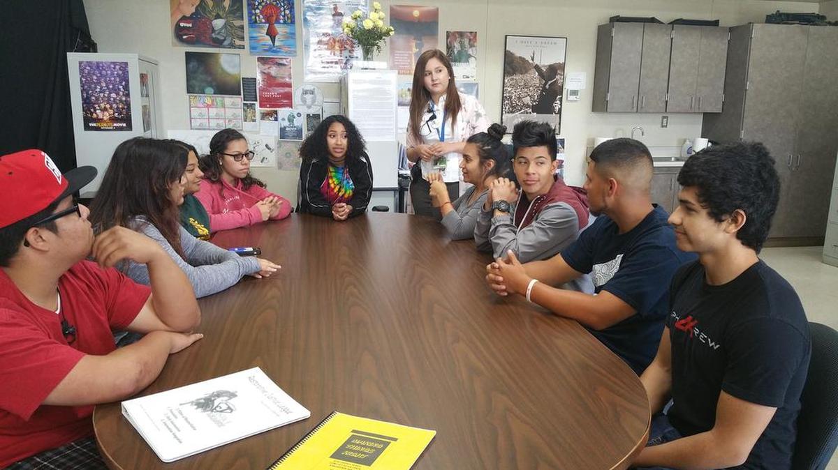 Students gather around a table at Le Grand High School, where restorative justice has been working for five years.